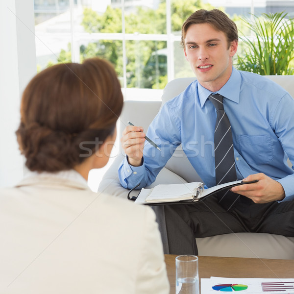 Young businessman scheduling with colleague sitting on couch Stock photo © wavebreak_media