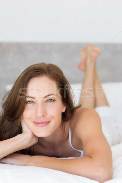 Closeup of a pretty smiling woman lying in bed Stock photo © wavebreak_media