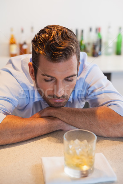 Drunk businessman looking at his whiskey glass  Stock photo © wavebreak_media
