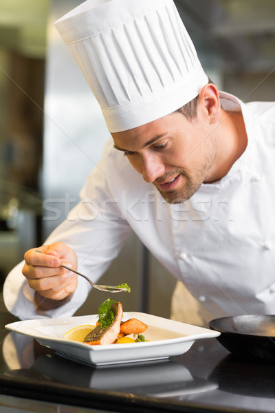Smiling male chef garnishing food in kitchen Stock photo © wavebreak_media