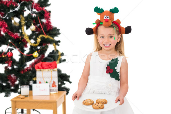 Festive little girl holding fresh cookies Stock photo © wavebreak_media