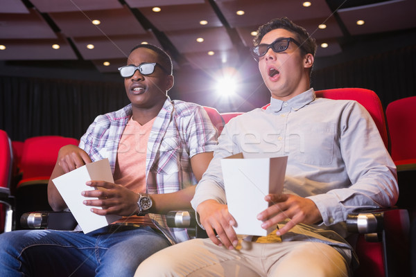 Astonished young friends watching 3d film Stock photo © wavebreak_media