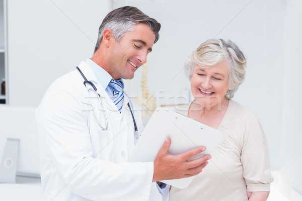 Doctor and patient discussing over reports Stock photo © wavebreak_media