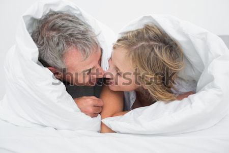Mother and daughter rubbing noses on sofa Stock photo © wavebreak_media