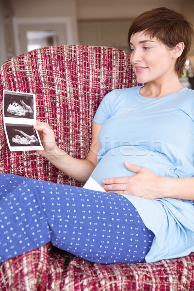 Hamile kadın bakıyor ultrason ev oturma odası ev Stok fotoğraf © wavebreak_media