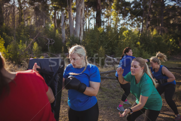 Stock photo: Woman practicing boxing in the boot camp