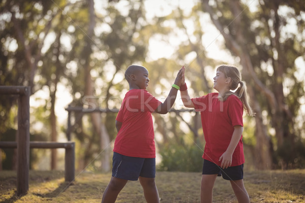 Happy kids giving high five during obstacle course Stock photo © wavebreak_media