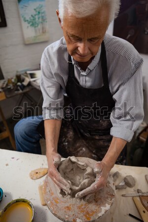 Attentive senior woman molding clay Stock photo © wavebreak_media
