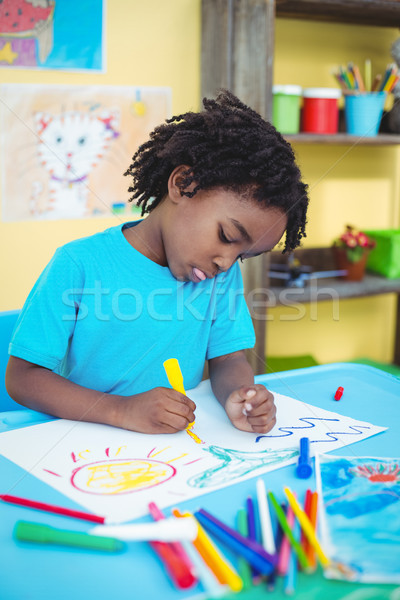 Happy kid drawing on his sheet Stock photo © wavebreak_media