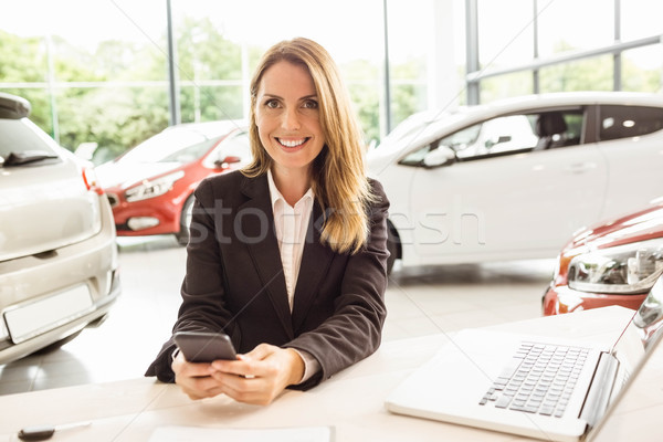 Smiling saleswoman having a phone call Stock photo © wavebreak_media