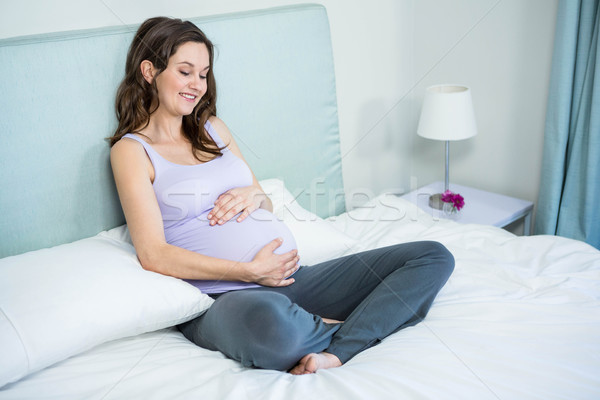 Pregnant woman touching her belly Stock photo © wavebreak_media