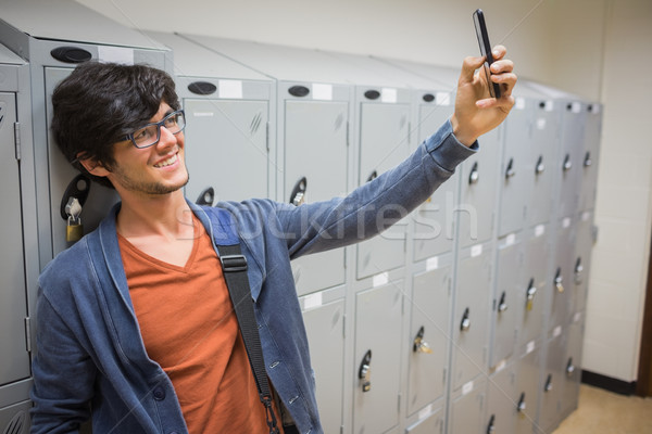 Smiling student taking selfie in locker room Stock photo © wavebreak_media