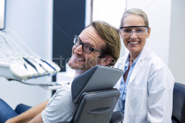 Female dentist and male patient smiling Stock photo © wavebreak_media