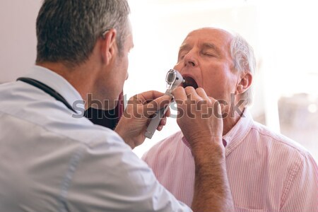 Female optometrist examining young patient with ophthalmoscope Stock photo © wavebreak_media