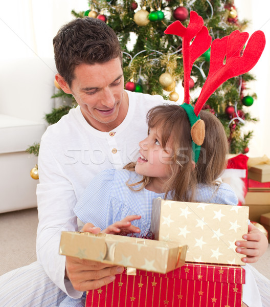 Stock photo: Portrait of a smiling father and his daughter opening Christmas 