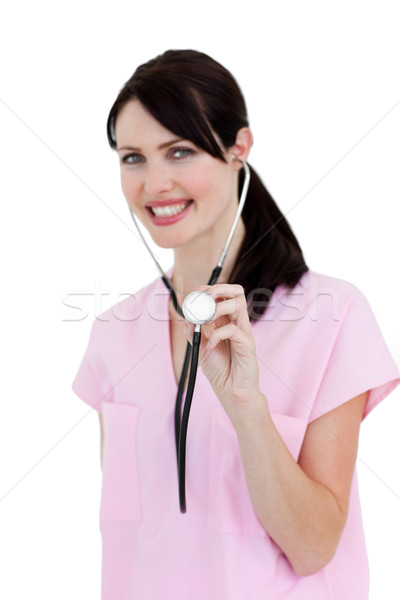 Stock photo: Radiant nurse showing a stethoscope against a white background