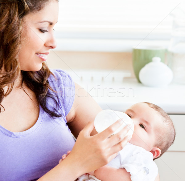 Radiant mother feeding her adorable son in the kitchen at home Stock photo © wavebreak_media