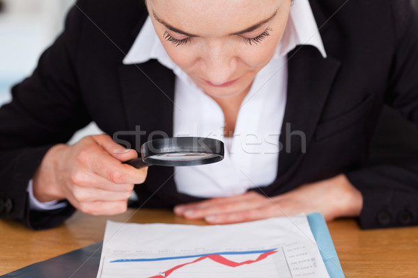 Mulher olhando traçar lupa escritório Foto stock © wavebreak_media