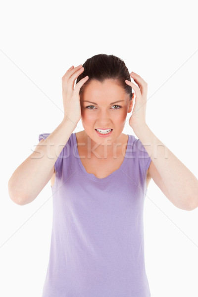 Good looking woman having a migraine while standing against a white background Stock photo © wavebreak_media