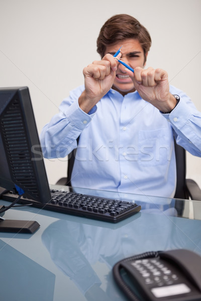 Angry young businessman just broke his pencil Stock photo © wavebreak_media