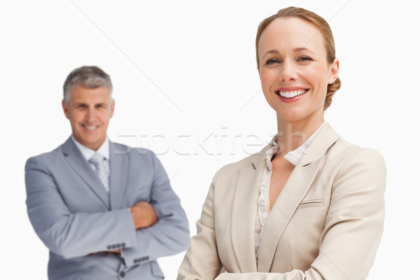 Happy business people with folded arms against white background Stock photo © wavebreak_media