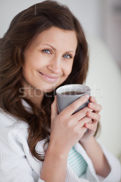 Kadın kupa kahve bakıyor kamera Stok fotoğraf © wavebreak_media