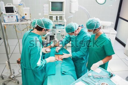 Surgeons and nurses around a patient in an operating theatre Stock photo © wavebreak_media