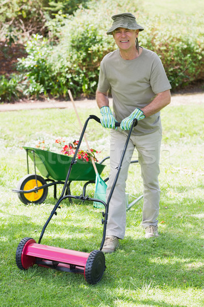 Smiling man mowing lawn Stock photo © wavebreak_media