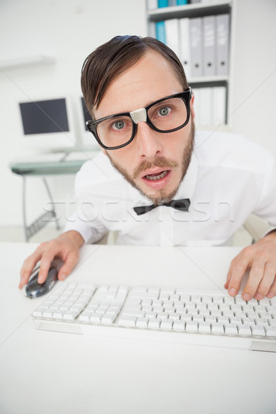 Nerdy shocked businessman working on computer  Stock photo © wavebreak_media