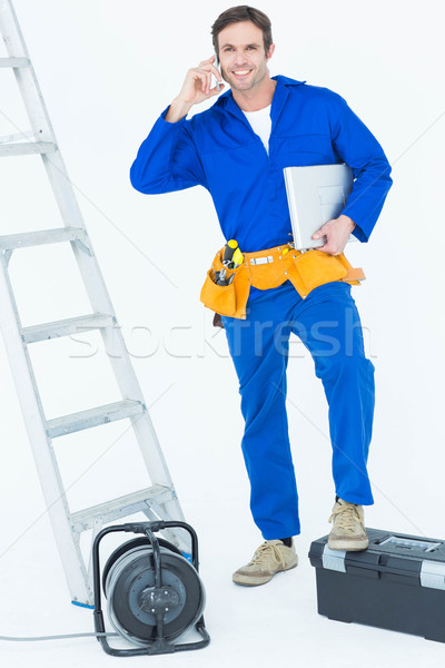 Electrician with leg on tool box using mobile phone Stock photo © wavebreak_media