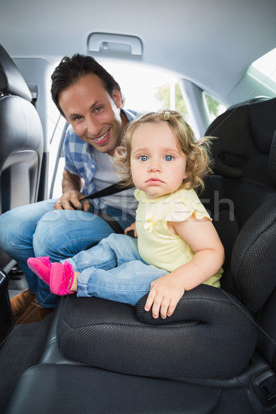 Father securing his baby in the car seat Stock photo © wavebreak_media