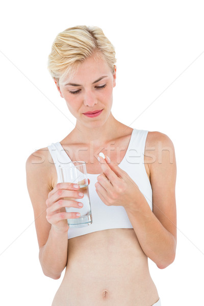 Uygun sarışın kadın bakıyor hap cam su Stok fotoğraf © wavebreak_media