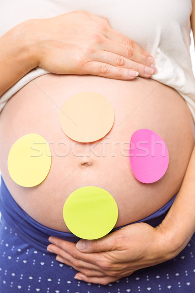 Pregnant woman with stickers on bump Stock photo © wavebreak_media