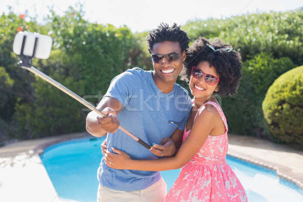 Happy couple using a selfie stick Stock photo © wavebreak_media