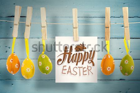 Grey type on note on washing line with eggs against yellow sky Stock photo © wavebreak_media