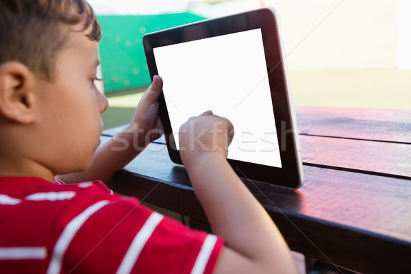 Close up of boy touching digital tablet while sitting at table Stock photo © wavebreak_media