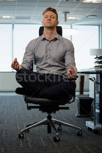 Executive meditating at desk Stock photo © wavebreak_media