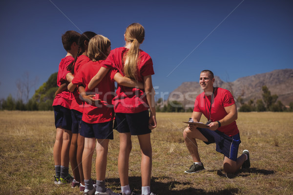 Trainer instructing kids in the boot camp Stock photo © wavebreak_media
