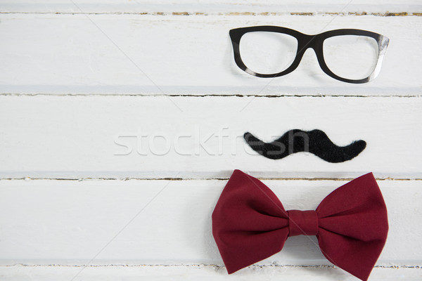 Close up of eyeglasses and bow tie arranged with mustache on table Stock photo © wavebreak_media