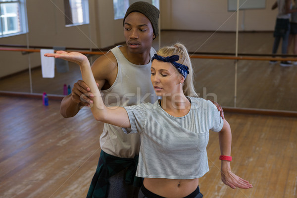 Man assisting female friend in dance against mirror Stock photo © wavebreak_media