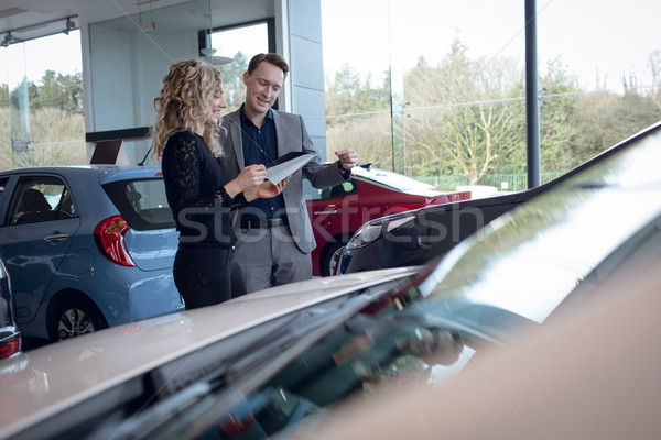 Customer and salesman reading brochure Stock photo © wavebreak_media