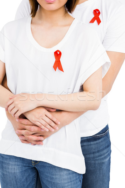 Midsection of man and woman with red ribbon Stock photo © wavebreak_media