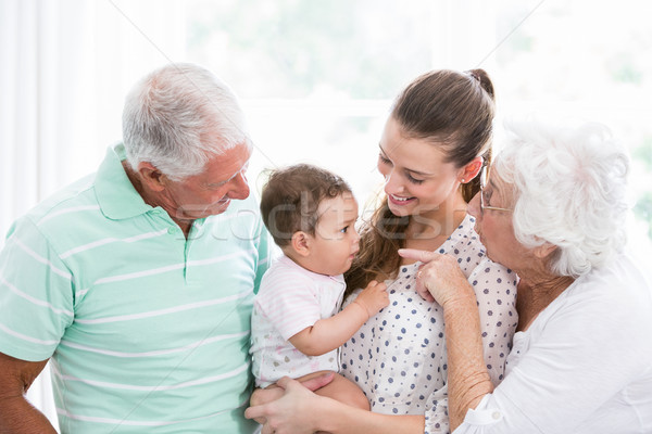 Souriant grands-parents mère jouer bébé maison [[stock_photo]] © wavebreak_media