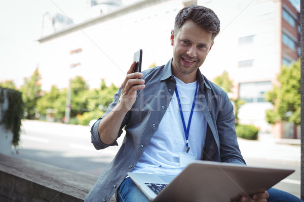 Yakışıklı iş yürütme cep telefonu dizüstü bilgisayar Stok fotoğraf © wavebreak_media