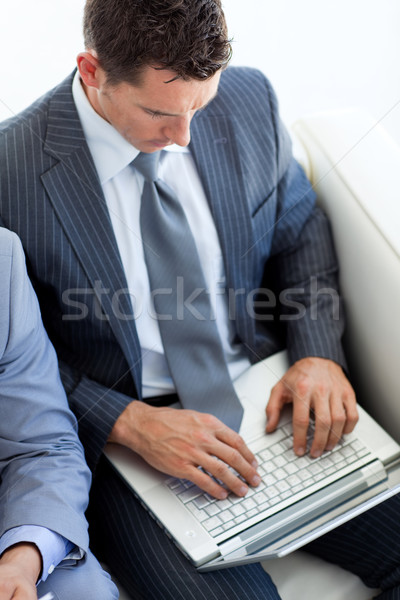 Atractivo empresario usando la computadora portátil espera Trabajo Foto stock © wavebreak_media