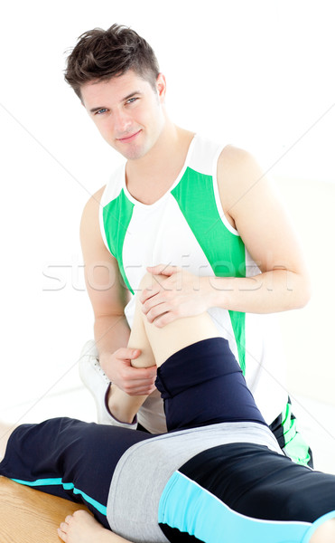 Young male physical therapist checking a woman's knee  Stock photo © wavebreak_media