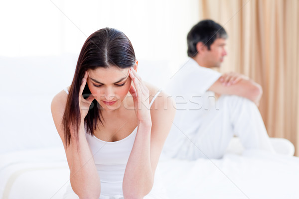 Sad couple having an argument sitting on bed at home Stock photo © wavebreak_media