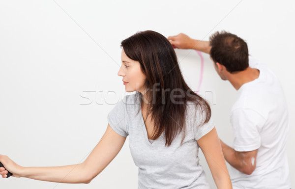 Man drawing a heart while his girlfriend painting a wall during a renovation Stock photo © wavebreak_media