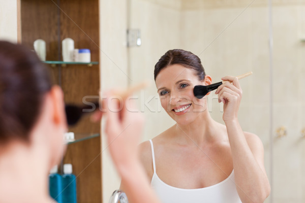 Beautiful women putting make up on  Stock photo © wavebreak_media