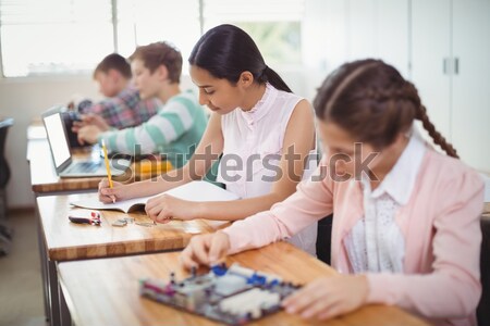 Studious young adults working on an essay in a classroom Stock photo © wavebreak_media